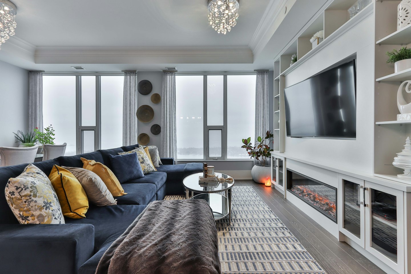 Modern living room with navy sectional and large windows.